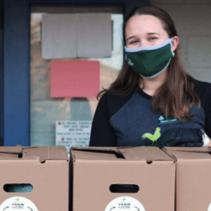 Alicia Loebl distributing free boxes of excess produce from farmers to students in need because of the pandemic or the wildfires.